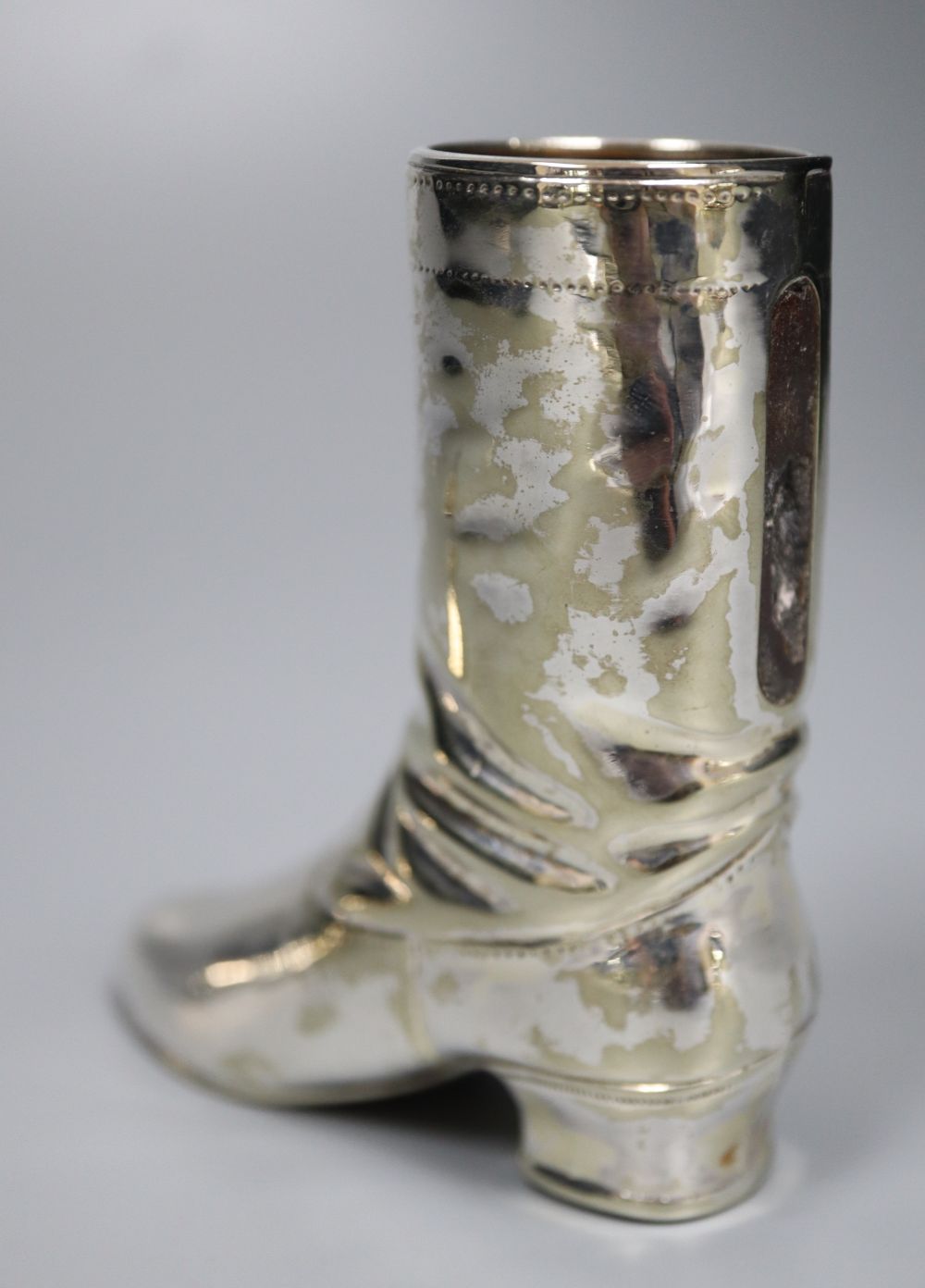 A silver novelty boot pin cushion, Levi & Salaman, Birmingham 1909 (lacking cushion),55m and a plated boot vesta